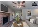 Staged living room with fireplace, couch, and adjacent dining area at 5723 Fieldstone Dr, Lithonia, GA 30038