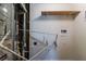 A cluttered utility room with exposed pipes, shelf, and a water heater ready for use at 5723 Fieldstone Dr, Lithonia, GA 30038