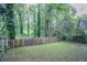 Fenced backyard with mature trees offers privacy at 941 Reed Ave, Atlanta, GA 30344