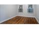 Bedroom featuring warm hardwood floors, two windows, and paneled walls at 941 Reed Ave, Atlanta, GA 30344
