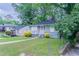 Inviting exterior showcasing a covered porch, well-maintained lawn, and attractive curb appeal at 941 Reed Ave, Atlanta, GA 30344