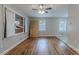 Spacious living room featuring hardwood floors, modern fan, and large windows at 941 Reed Ave, Atlanta, GA 30344