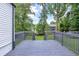 View from the deck looking out to the backyard with mature trees and lake views at 1398 Woodland Ave, Atlanta, GA 30316