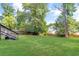 Sprawling backyard with lush green grass, privacy fence and mature trees overhead at 1398 Woodland Ave, Atlanta, GA 30316