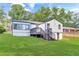 Large backyard with luscious green grass and stairs leading up to the back deck at 1398 Woodland Ave, Atlanta, GA 30316