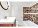 Cozy bathroom showcasing mosaic tiled walls with white sink, toilet, and tub at 1398 Woodland Ave, Atlanta, GA 30316