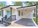 Charming home exterior featuring a light blue front door and covered parking area at 1398 Woodland Ave, Atlanta, GA 30316