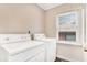 Functional laundry room featuring a washer, dryer, and natural light at 1398 Woodland Ave, Atlanta, GA 30316