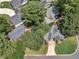 An aerial view of a lovely single-Gathering home surrounded by lush greenery and mature trees at 141 S Fairfield Dr, Peachtree City, GA 30269