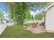 Secluded backyard with a patio, green lawn, and a white picket fence at 141 S Fairfield Dr, Peachtree City, GA 30269