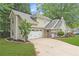 Charming two-story home with a two-car garage, well-maintained lawn and mature landscaping at 141 S Fairfield Dr, Peachtree City, GA 30269