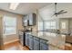 Open-concept kitchen with stainless appliances, granite counters, and seamless flow to the living room at 141 S Fairfield Dr, Peachtree City, GA 30269