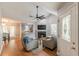 Cozy living room with vaulted ceilings, a fireplace, hardwood floors, and an open concept design at 141 S Fairfield Dr, Peachtree City, GA 30269