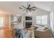 Bright living room with vaulted ceiling, fireplace, hardwood floors, and access to the kitchen at 141 S Fairfield Dr, Peachtree City, GA 30269