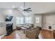 Comfortable living room featuring vaulted ceilings, a modern ceiling fan, and a cozy fireplace at 141 S Fairfield Dr, Peachtree City, GA 30269
