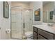 Modern bathroom with glass shower, vanity, decorative lighting, and artwork on the wall at 2444 Coosa Vly, Atlanta, GA 30339