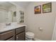 Bathroom featuring modern sink, vanity and faucet, framed pictures, and shower with curtain at 2444 Coosa Vly, Atlanta, GA 30339