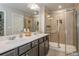 Elegant bathroom boasts a double vanity, tile flooring, and a glass-enclosed shower at 2444 Coosa Vly, Atlanta, GA 30339