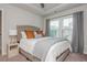 Comfortable bedroom features a tray ceiling, a large window with natural light, and modern decor at 2444 Coosa Vly, Atlanta, GA 30339