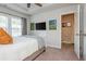 Bright bedroom boasts a tray ceiling, en-suite bathroom, and a view of the outdoors through large windows at 2444 Coosa Vly, Atlanta, GA 30339