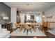 Open dining area with a view to the kitchen and stairs to the upper level, features a modern light fixture at 2444 Coosa Vly, Atlanta, GA 30339