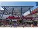Entrance view of the Atlanta Braves stadium showcasing crowds and signage under a clear blue sky at 2444 Coosa Vly, Atlanta, GA 30339