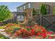 Charming Creekview community entrance with brick signage, stone accents, and vibrant red flowers at 2444 Coosa Vly, Atlanta, GA 30339