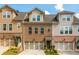 Charming townhome features a brick facade, two-car garage, and well-manicured landscaping at 2444 Coosa Vly, Atlanta, GA 30339
