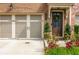 Charming front entrance with a brown door, a garage, and colorful landscaping at 2444 Coosa Vly, Atlanta, GA 30339