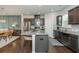 Modern kitchen features stainless steel appliances, granite countertops, and a large island with seating at 2444 Coosa Vly, Atlanta, GA 30339