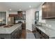 This updated kitchen offers granite countertops, stainless steel appliances, and dark wood cabinetry at 2444 Coosa Vly, Atlanta, GA 30339