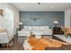 Stylish living room with a decorative blue accent wall, comfortable seating, and warm hardwood flooring at 2444 Coosa Vly, Atlanta, GA 30339