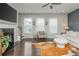 Bright living space with fireplace, multiple windows, an accent chair, and views of the outdoors at 2444 Coosa Vly, Atlanta, GA 30339