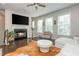 Cozy living room with fireplace, hardwood floors, and an abundance of natural light at 2444 Coosa Vly, Atlanta, GA 30339