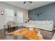 Comfortable living room featuring a modern sofa, accent chair, decorative wall paneling, and hardwood floors at 2444 Coosa Vly, Atlanta, GA 30339
