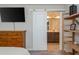 Bedroom with barn door leading to a primary bathroom with dual vanities at 2444 Coosa Vly, Atlanta, GA 30339