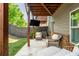 Covered patio with outdoor seating, TV, and landscaped backyard at 2444 Coosa Vly, Atlanta, GA 30339
