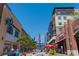 Street view showcasing shops, apartments, restaurants, and a pedestrian walkway on a sunny day at 2444 Coosa Vly, Atlanta, GA 30339