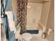 Bathroom with shower-tub combo, decorative shower curtain, and blue towels at 365 Autumn Breeze Dr, Roswell, GA 30075