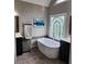 Bright bathroom features a soaking tub beneath a stained glass window and modern fixtures at 365 Autumn Breeze Dr, Roswell, GA 30075