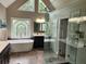 Modern bathroom featuring a soaking tub, glass enclosed shower, double vanity and decorative lighting at 365 Autumn Breeze Dr, Roswell, GA 30075