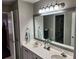 Bathroom features a double vanity, large mirror, and updated fixtures at 365 Autumn Breeze Dr, Roswell, GA 30075
