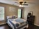 Bedroom features dark wood floors, two windows and a full sized bed at 365 Autumn Breeze Dr, Roswell, GA 30075