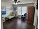 Well-lit bedroom features hardwood floors, neutral paint and a traditional armoire at 365 Autumn Breeze Dr, Roswell, GA 30075