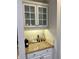 Convenient coffee bar nook with upper cabinets, granite countertop, and space for coffee machines at 365 Autumn Breeze Dr, Roswell, GA 30075