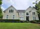 Elegant two-story home featuring a well-manicured lawn and symmetrical window placement at 365 Autumn Breeze Dr, Roswell, GA 30075