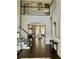 Bright foyer with hardwood floors and stairway featuring decorative trim details and high ceilings at 365 Autumn Breeze Dr, Roswell, GA 30075