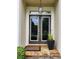 Close-up of the front door with decorative lighting and stone pathway at 365 Autumn Breeze Dr, Roswell, GA 30075