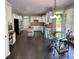 Open concept kitchen with a breakfast area, white cabinets, and stainless steel appliances at 365 Autumn Breeze Dr, Roswell, GA 30075
