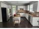 Well-equipped kitchen with white cabinets, granite countertops, stainless steel appliances and tile backsplash at 365 Autumn Breeze Dr, Roswell, GA 30075